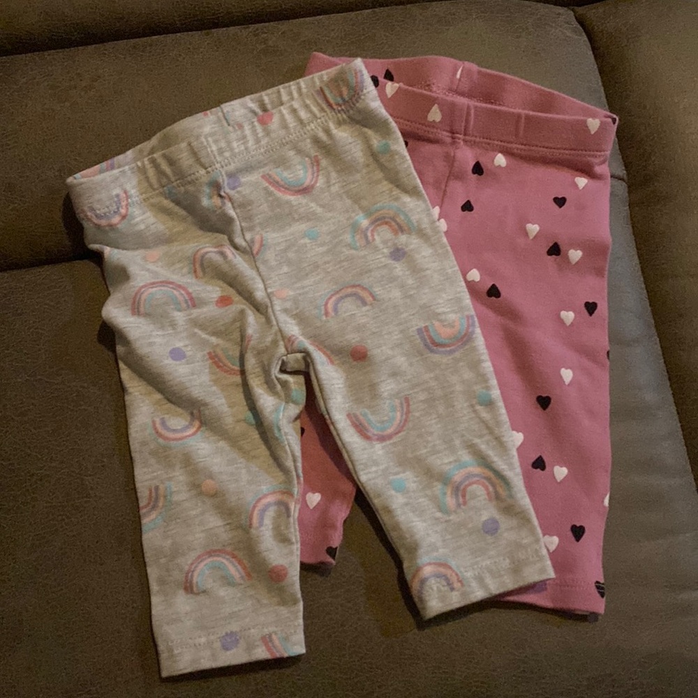 1- pink leggings with black and white hearts, 1- grey leggings with rainbows
